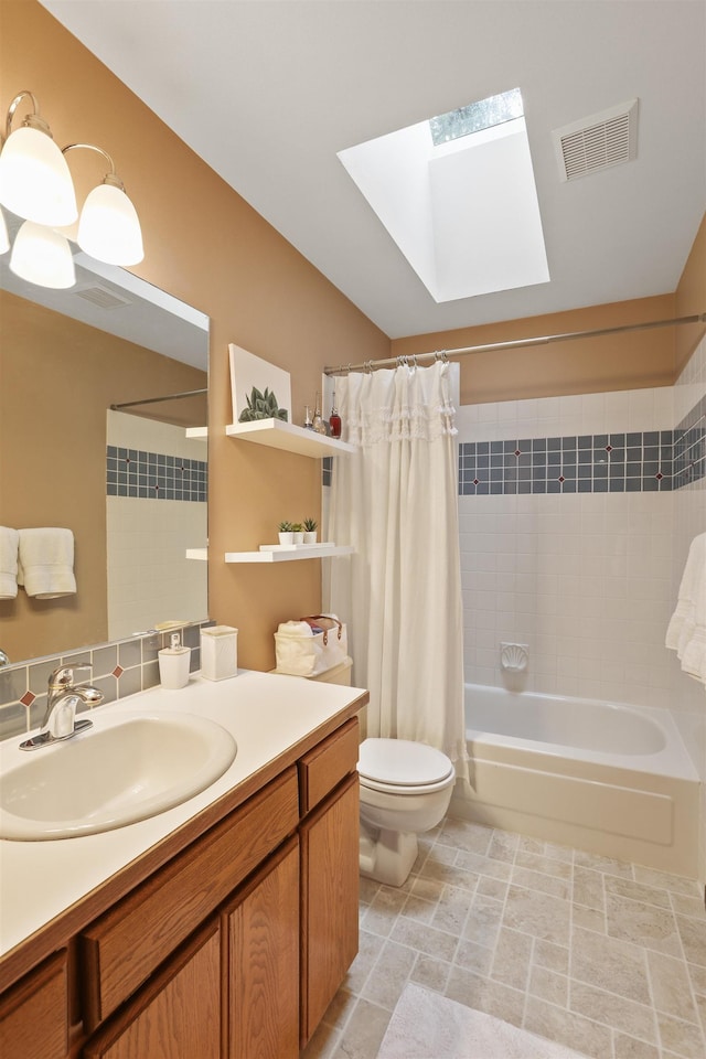 339 W Wilson Ave, Spokane, WA 99208 - bathroom featuring a skylight, shower / bath combo with shower curtain, and vanity