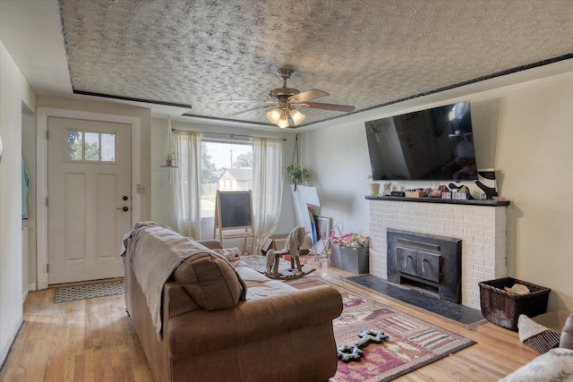2804 E Marshall Ave, Spokane, WA 99207 - living area with wood finished floors, a fireplace, and ceiling fan