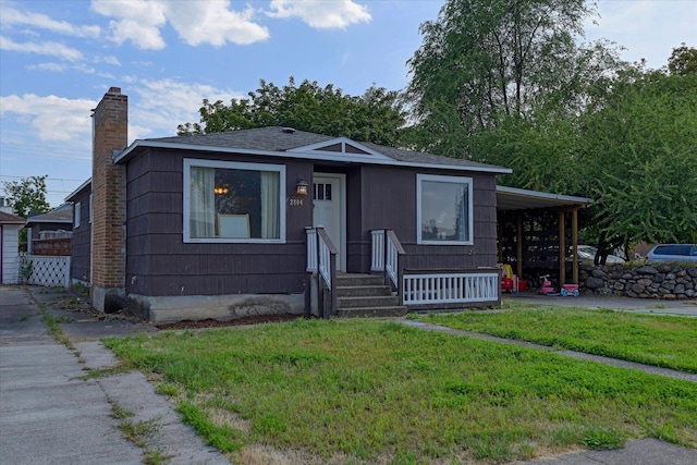 2804 E Marshall Ave, Spokane, WA 99207 - view of front of house featuring a front yard, a chimney, and roof with shingles