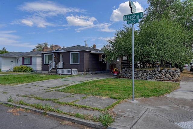 2804 E Marshall Ave, Spokane, WA 99207 - view of front of house with a front lawn and a chimney