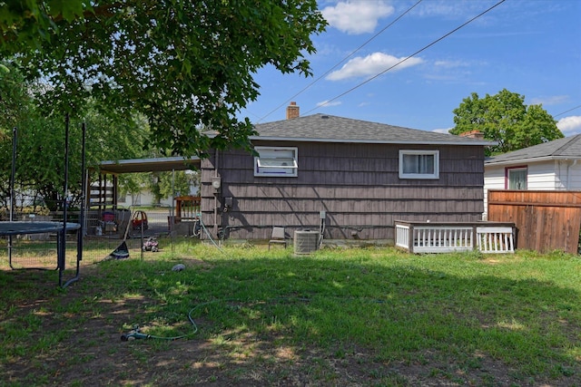 2804 E Marshall Ave, Spokane, WA 99207 - view of home's exterior featuring a trampoline, a fenced backyard, and roof with shingles