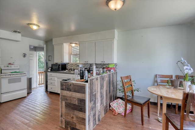 2804 E Marshall Ave, Spokane, WA 99207 - kitchen with electric stove, black microwave, white cabinetry, and wood finished floors