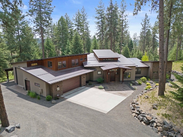 25204 N Lords Ln, Chattaroy, WA 99003 - view of front of property featuring concrete driveway, a metal roof, an attached garage, a standing seam roof, and brick siding