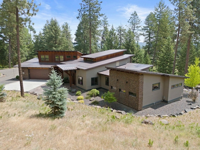 25204 N Lords Ln, Chattaroy, WA 99003 - view of front of property featuring driveway, an attached garage, and a metal roof