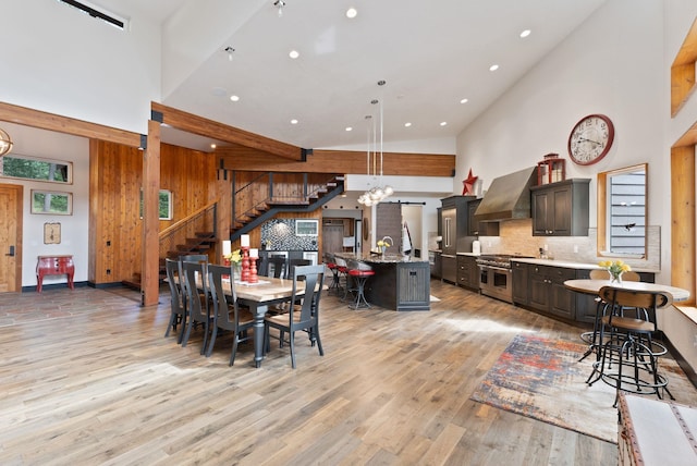 25204 N Lords Ln, Chattaroy, WA 99003 - dining space featuring stairs, a high ceiling, light wood-style floors, recessed lighting, and a chandelier