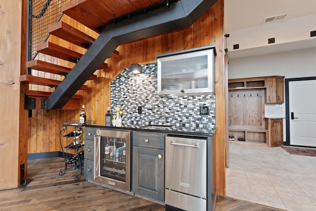 25204 N Lords Ln, Chattaroy, WA 99003 - indoor bar featuring beverage cooler, wood walls, wood finished floors, and decorative backsplash