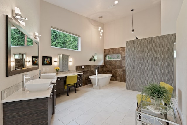 25204 N Lords Ln, Chattaroy, WA 99003 - full bathroom with tile walls, double vanity, a freestanding bath, a towering ceiling, and a walk in shower