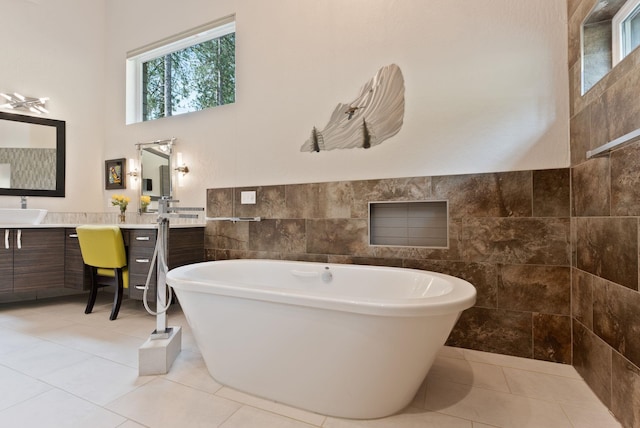 25204 N Lords Ln, Chattaroy, WA 99003 - bathroom with tile walls, a soaking tub, vanity, a high ceiling, and tile patterned floors