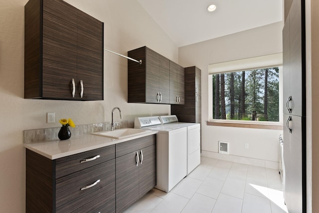 25204 N Lords Ln, Chattaroy, WA 99003 - laundry area featuring cabinet space, washing machine and clothes dryer, and light tile patterned flooring