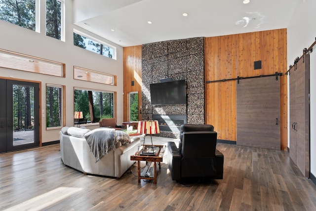 25204 N Lords Ln, Chattaroy, WA 99003 - living area featuring a high ceiling, a barn door, recessed lighting, wood finished floors, and a large fireplace