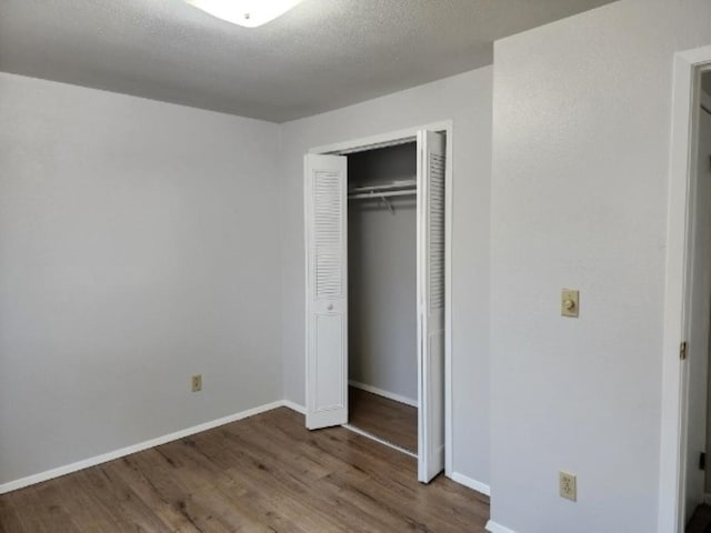 704 E Beacon Ave, Spokane, WA 99208 - unfurnished bedroom featuring wood finished floors and a closet