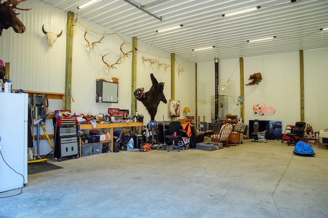 191 Amherst Ln, Newport, WA 99156 - garage with freestanding refrigerator and a workshop area