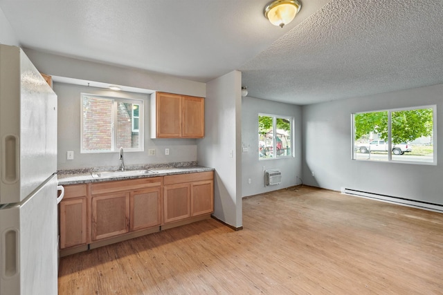 1907 E Sinto Ave, Spokane, WA 99202 - kitchen featuring freestanding refrigerator, light wood-style flooring, an AC wall unit, a textured ceiling, and light countertops