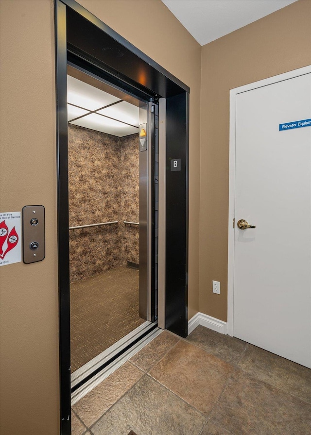 1828 W Riverside Ave Unit 301, Spokane, WA 99201 - doorway with baseboards and elevator