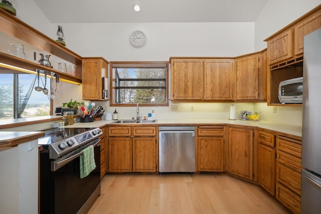 21407 W Baker Rd, Cheney, WA 99004 - kitchen featuring appliances with stainless steel finishes, brown cabinetry, light countertops, and light wood-type flooring