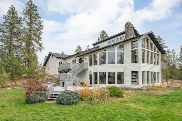 21407 W Baker Rd, Cheney, WA 99004 - back of house featuring a wooden deck, a chimney, stairway, a lawn, and a sunroom