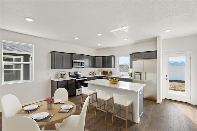 1321 E 12th St, Deer Park, WA 99006 - kitchen featuring stainless steel appliances, a kitchen island, dark wood-type flooring, light countertops, and recessed lighting