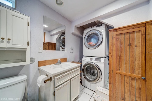 203 N Mcdonald Rd, Spokane, WA 99216 - laundry room featuring estacked washer and dryer and light tile patterned floors