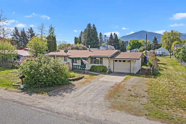 150 E 9th Ave, Kettle Falls, WA 99141 - ranch-style home featuring driveway, a garage, and a mountain view