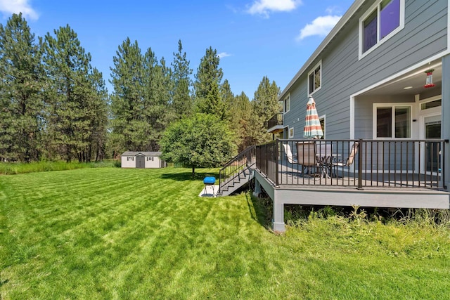 11625 N Alberta Ln, Spokane, WA 99218 - view of green lawn with a wooden deck and a storage unit
