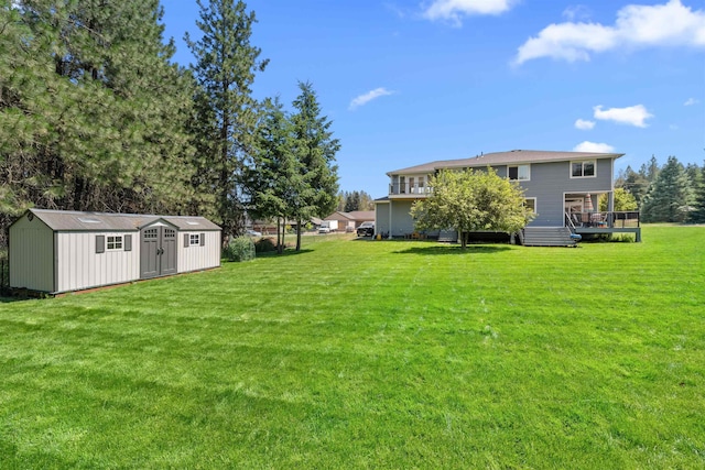 11625 N Alberta Ln, Spokane, WA 99218 - view of grassy yard featuring a storage unit and a deck