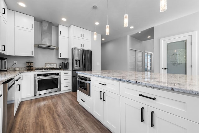 11625 N Alberta Ln, Spokane, WA 99218 - kitchen with appliances with stainless steel finishes, wall chimney exhaust hood, dark wood finished floors, light stone countertops, and hanging light fixtures
