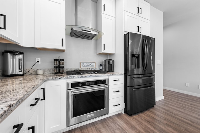 11625 N Alberta Ln, Spokane, WA 99218 - kitchen featuring appliances with stainless steel finishes, wall chimney range hood, dark wood-style flooring, white cabinetry, and light stone counters