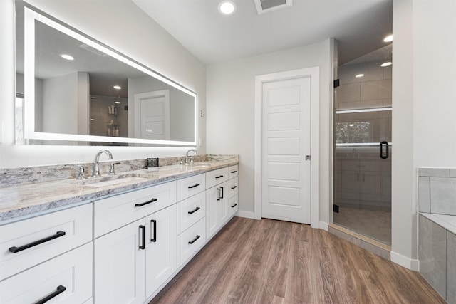 11625 N Alberta Ln, Spokane, WA 99218 - bathroom featuring double vanity, a stall shower, wood finished floors, and recessed lighting