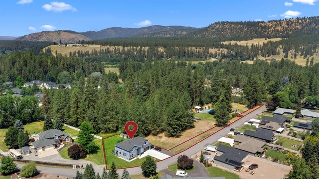 11625 N Alberta Ln, Spokane, WA 99218 - aerial perspective of suburban area featuring a heavily wooded area and a mountain backdrop