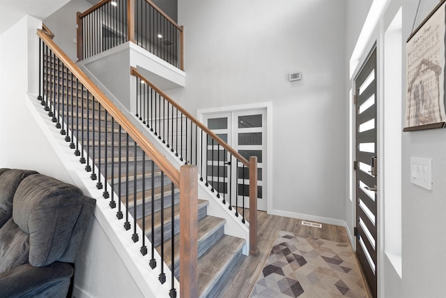 11625 N Alberta Ln, Spokane, WA 99218 - foyer with wood finished floors, a high ceiling, and stairway