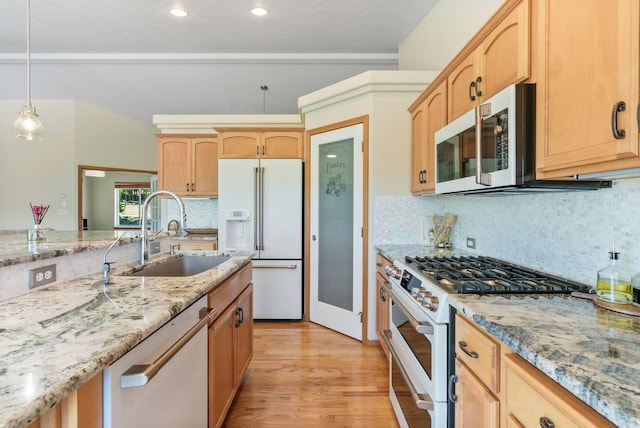 711 W Bolan Ave, Spokane, WA 99224 - kitchen featuring stainless steel appliances, light brown cabinetry, light wood-type flooring, light stone counters, and decorative backsplash