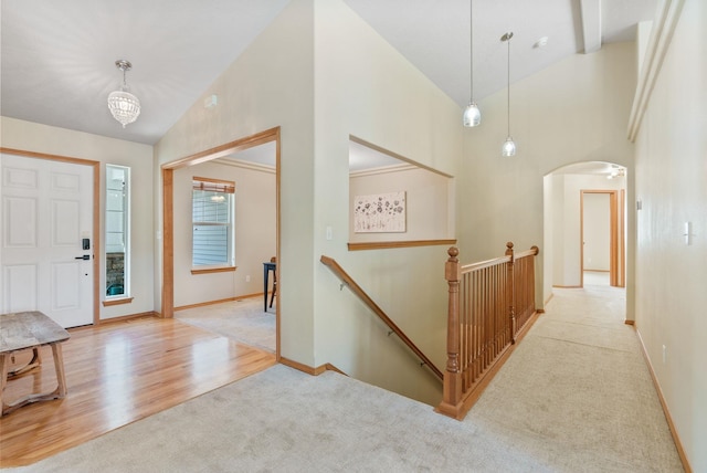 711 W Bolan Ave, Spokane, WA 99224 - foyer featuring carpet, arched walkways, high vaulted ceiling, a chandelier, and wood finished floors
