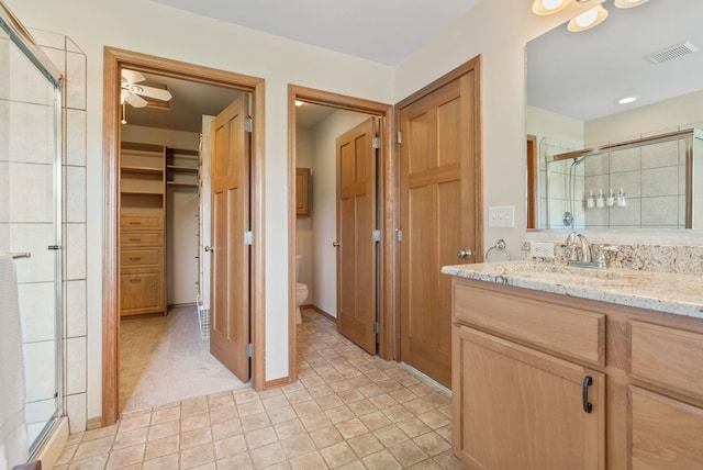 711 W Bolan Ave, Spokane, WA 99224 - full bath featuring a stall shower, vanity, a spacious closet, and tile patterned floors