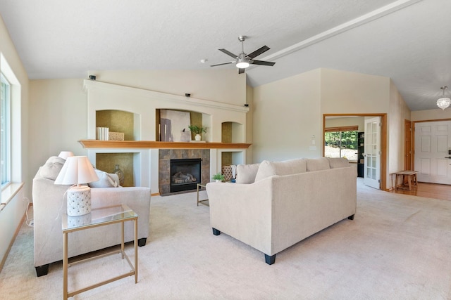 711 W Bolan Ave, Spokane, WA 99224 - living room featuring vaulted ceiling, carpet flooring, a fireplace, and a ceiling fan