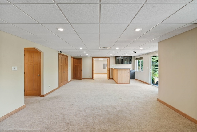 711 W Bolan Ave, Spokane, WA 99224 - unfurnished living room featuring light carpet, arched walkways, recessed lighting, bar area, and a paneled ceiling