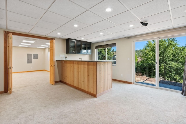 711 W Bolan Ave, Spokane, WA 99224 - kitchen with light colored carpet, glass insert cabinets, a peninsula, a drop ceiling, and recessed lighting