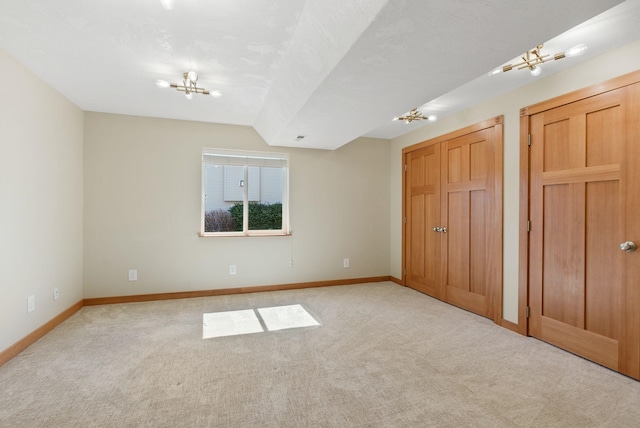 711 W Bolan Ave, Spokane, WA 99224 - unfurnished bedroom with light colored carpet and a chandelier