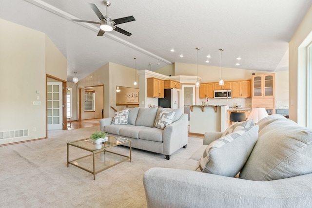 711 W Bolan Ave, Spokane, WA 99224 - living room with vaulted ceiling, light colored carpet, ceiling fan, and recessed lighting