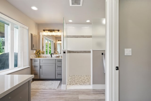 5159 W Village Blvd, Rathdrum, ID 83858 - bathroom with vanity, walk in shower, wood finished floors, and recessed lighting