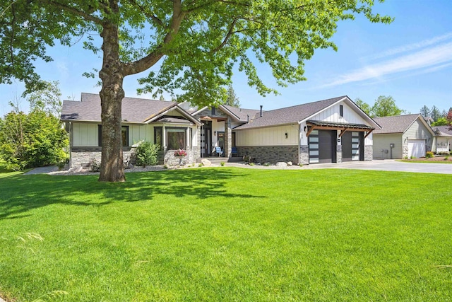 5159 W Village Blvd, Rathdrum, ID 83858 - view of front of property featuring stone siding, concrete driveway, an attached garage, and a front yard
