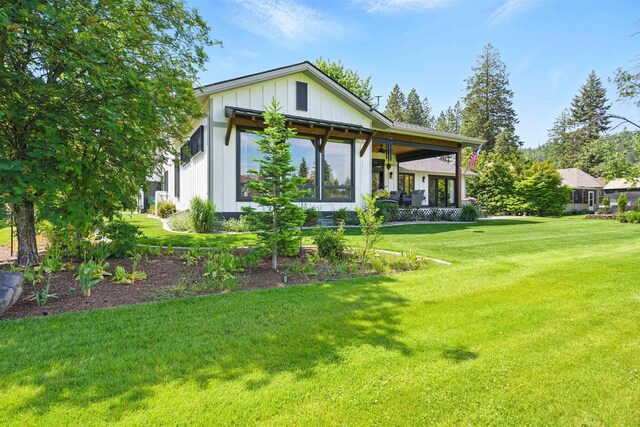 5159 W Village Blvd, Rathdrum, ID 83858 - rear view of property with a lawn and board and batten siding
