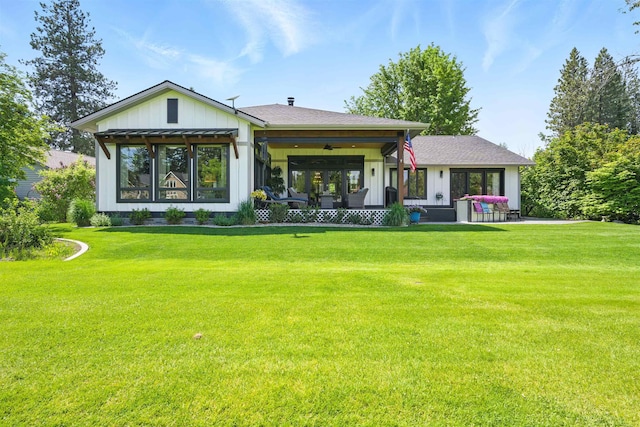 5159 W Village Blvd, Rathdrum, ID 83858 - rear view of property with a lawn and board and batten siding
