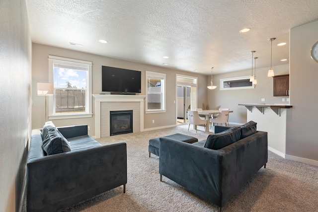1101 S Pillar Rock Dr, Spokane, WA 99224 - living area with carpet, a textured ceiling, recessed lighting, and a glass covered fireplace