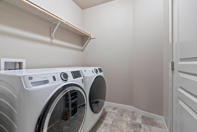 1101 S Pillar Rock Dr, Spokane, WA 99224 - laundry room featuring separate washer and dryer and light stone finish floors