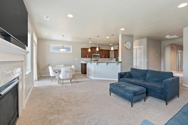 1101 S Pillar Rock Dr, Spokane, WA 99224 - living area featuring arched walkways, light carpet, and recessed lighting