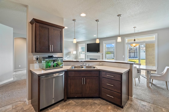 1101 S Pillar Rock Dr, Spokane, WA 99224 - kitchen featuring stainless steel dishwasher, a peninsula, dark brown cabinets, light countertops, and a textured ceiling