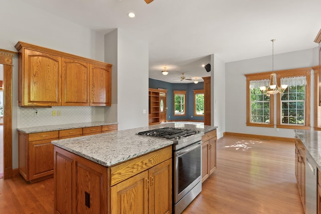 3810 E Evan Ln, Colbert, WA 99005 - kitchen featuring gas range, ceiling fan, light wood-style flooring, and brown cabinetry