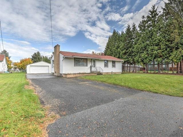 2520 N Bradley Rd, Spokane, WA 99212 - view of front of house featuring a chimney, an outbuilding, a garage, and a front yard