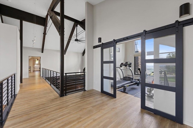 2503 S Thierman Ln, Spokane, WA 99223 - hallway featuring a barn door, high vaulted ceiling, light wood-style flooring, french doors, and beamed ceiling