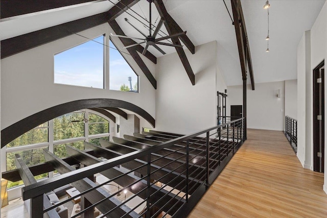 2503 S Thierman Ln, Spokane, WA 99223 - staircase with high vaulted ceiling, beamed ceiling, wood finished floors, and arched walkways